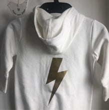 Load image into Gallery viewer, this is a cream organic babygro with a gold printed lightening bolt on it on it
